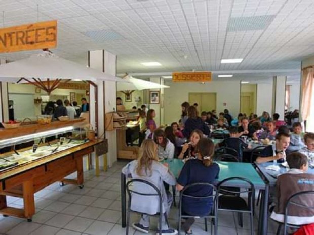 Enfants de la colonie de vacances mangent dans le réfectoire du centre de vacances à la montagne