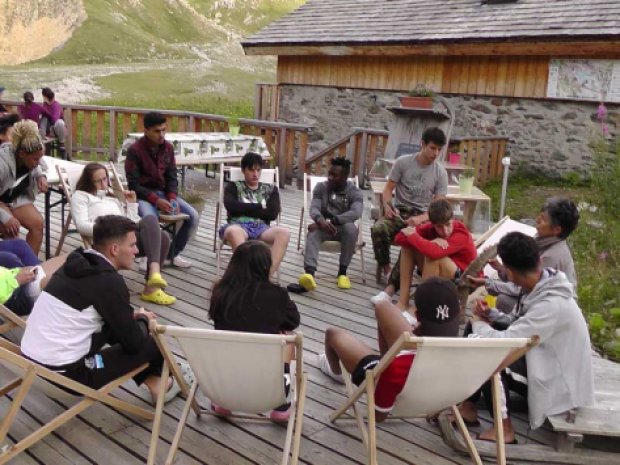 Jeunes en colonie de vacances se reposent sur des transat à la montagne